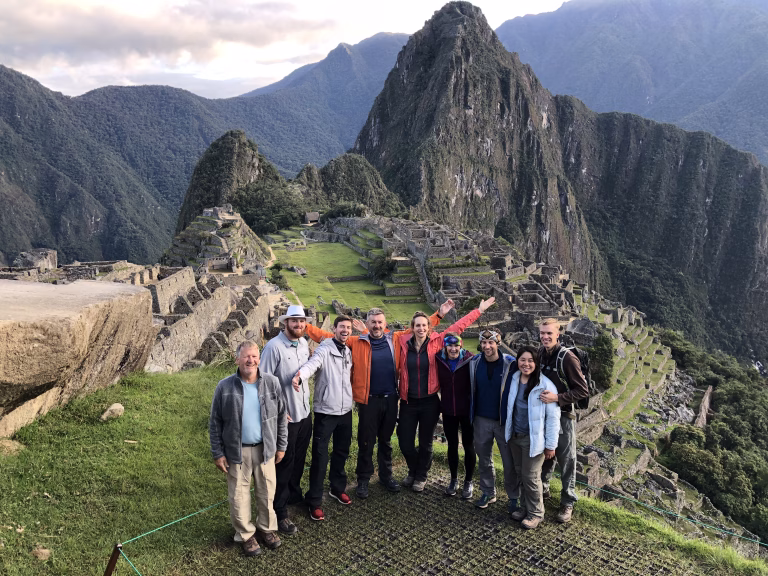 The iconic postcard view of Machu Picchu citadel with Huayna Picchu in the background.